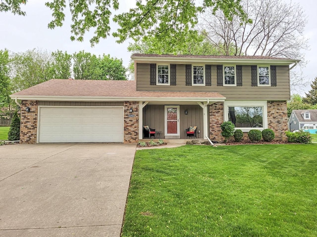 21755 W N Ave, Brookfield, WI 53045 - view of front of house featuring concrete driveway, a garage, brick siding, and a front lawn