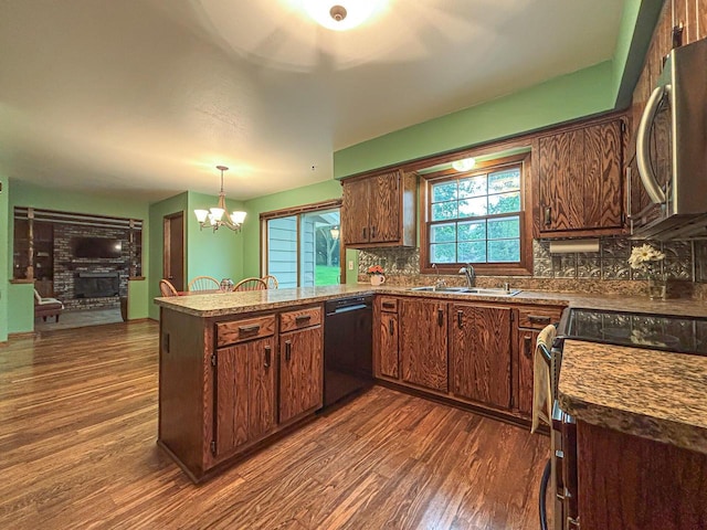 21755 W N Ave, Brookfield, WI 53045 - kitchen featuring black appliances, a peninsula, dark wood finished floors, and tasteful backsplash