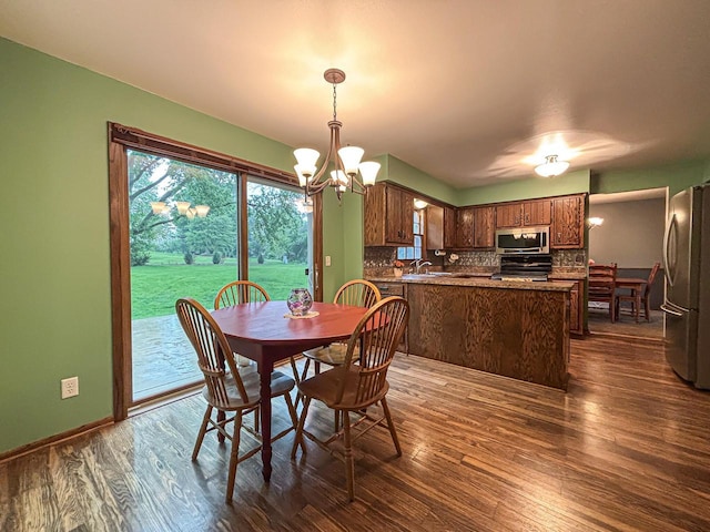 21755 W N Ave, Brookfield, WI 53045 - dining area featuring dark wood-style flooring, a chandelier, and baseboards