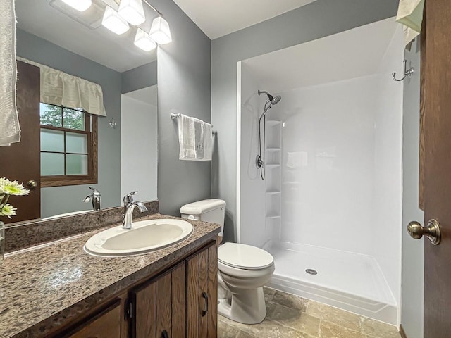 21755 W N Ave, Brookfield, WI 53045 - full bathroom with stone finish floors, toilet, a shower, and vanity