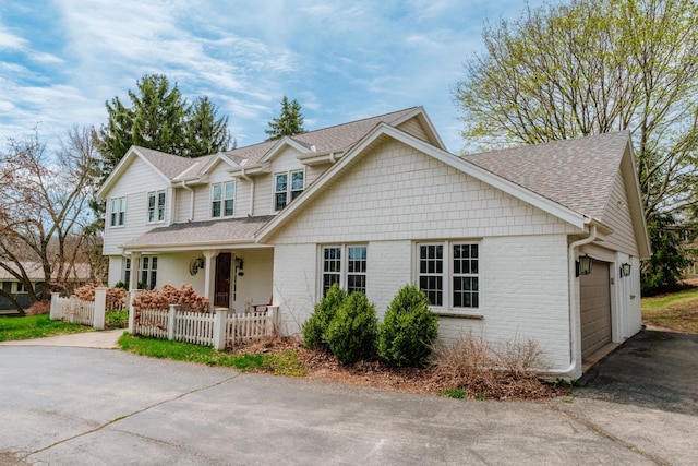 1305 Lexington Ct, Brookfield, WI 53045 - view of front of house with driveway, a garage, roof with shingles, covered porch, and brick siding