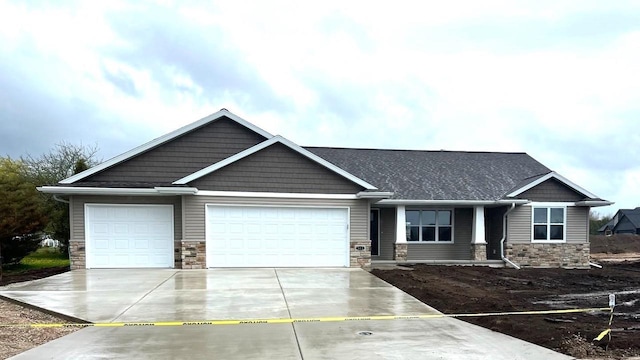 513 Kirkland Ave, Algoma, WI 54201 - craftsman inspired home with stone siding, an attached garage, and concrete driveway
