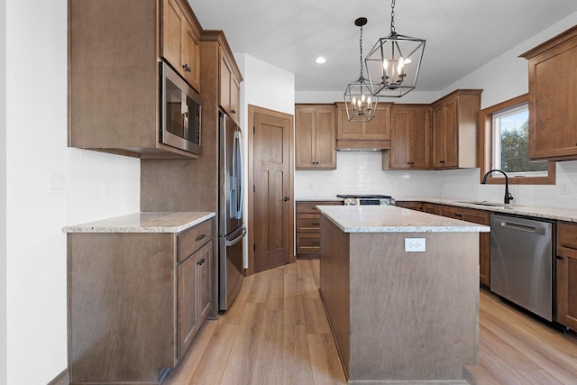 513 Kirkland Ave, Algoma, WI 54201 - kitchen with appliances with stainless steel finishes, a center island, light wood finished floors, a sink, and recessed lighting