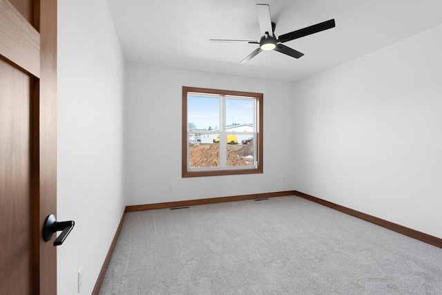 513 Kirkland Ave, Algoma, WI 54201 - spare room with light colored carpet, baseboards, and a ceiling fan
