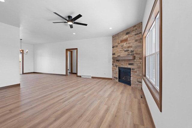 513 Kirkland Ave, Algoma, WI 54201 - unfurnished living room featuring a chandelier, a fireplace, light wood-style floors, plenty of natural light, and recessed lighting