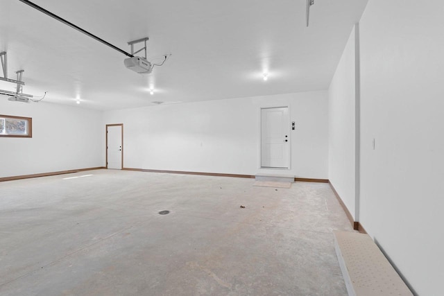 513 Kirkland Ave, Algoma, WI 54201 - garage with a garage door opener and baseboards