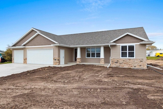 513 Kirkland Ave, Algoma, WI 54201 - craftsman-style home with stone siding, an attached garage, driveway, roof with shingles, and a porch