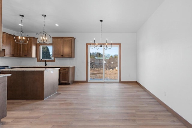 513 Kirkland Ave, Algoma, WI 54201 - kitchen with a chandelier, light wood-type flooring, baseboards, and recessed lighting
