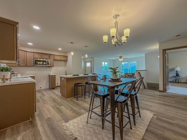 990 Morning Star Ln, Plover, WI 54467 - dining space with a chandelier, light wood-style floors, recessed lighting, baseboards, and ceiling fan