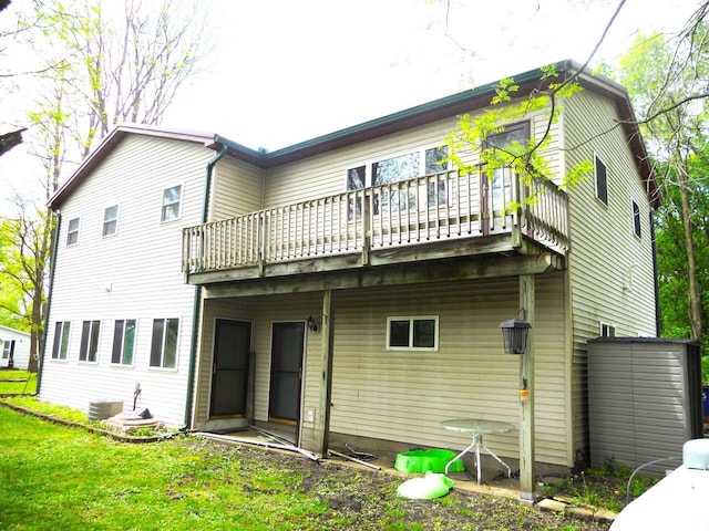 1129 Ember Dr, Adams, WI 53910 - rear view of house featuring central air condition unit, a yard, and a wooden deck