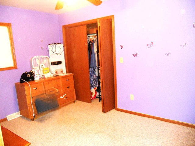 1129 Ember Dr, Adams, WI 53910 - bedroom with light colored carpet, a closet, ceiling fan, and baseboards