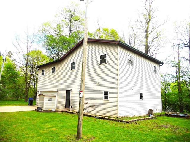 1129 Ember Dr, Adams, WI 53910 - view of property exterior featuring a yard and concrete driveway