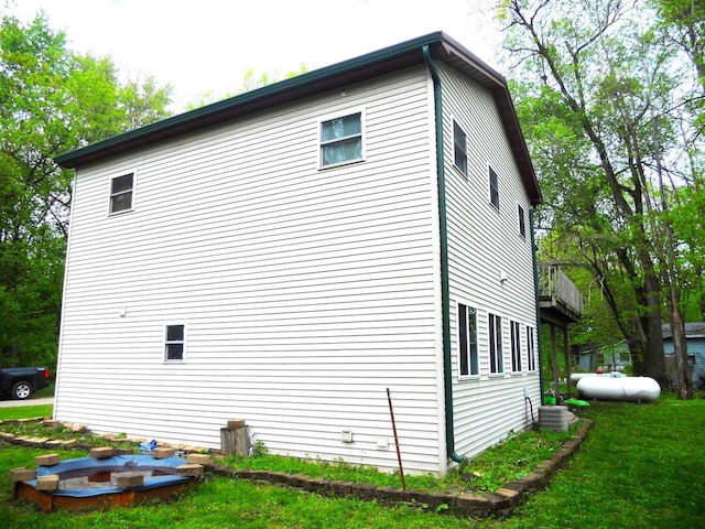 1129 Ember Dr, Adams, WI 53910 - view of side of home featuring a yard and cooling unit