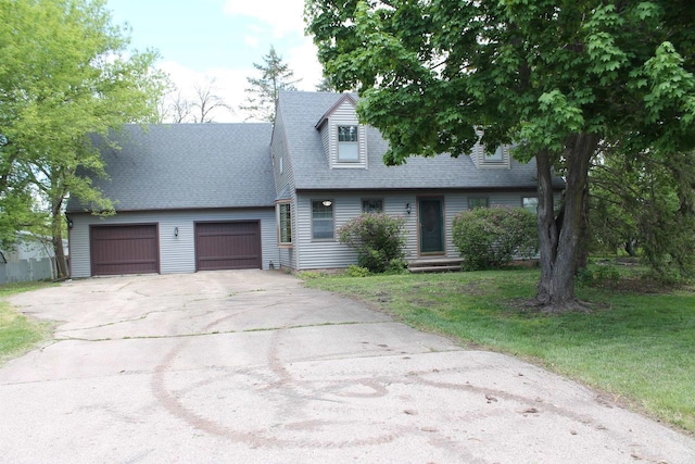 620 Oak St, Winneconne, WI 54986 - cape cod home with driveway, an attached garage, roof with shingles, and a front lawn
