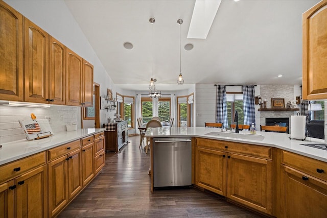 S91W35161 Prairie Ct, Eagle, WI 53119 - kitchen featuring stainless steel dishwasher, a sink, dark wood-style floors, tasteful backsplash, and lofted ceiling