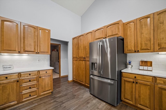 S91W35161 Prairie Ct, Eagle, WI 53119 - kitchen featuring stainless steel fridge, high vaulted ceiling, tasteful backsplash, light countertops, and brown cabinets