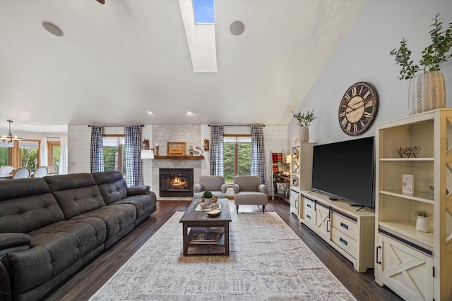 S91W35161 Prairie Ct, Eagle, WI 53119 - living area featuring a fireplace, dark wood-style floors, high vaulted ceiling, a chandelier, and recessed lighting