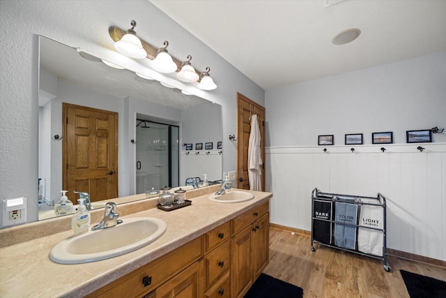 S91W35161 Prairie Ct, Eagle, WI 53119 - full bathroom with a shower stall, double vanity, wood finished floors, and a wainscoted wall