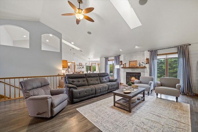S91W35161 Prairie Ct, Eagle, WI 53119 - living area with vaulted ceiling, ceiling fan, wood finished floors, a stone fireplace, and a skylight