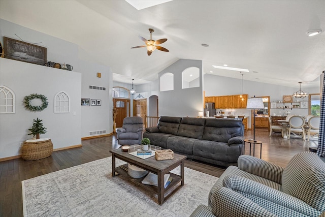 S91W35161 Prairie Ct, Eagle, WI 53119 - living area with a ceiling fan, a chandelier, wood finished floors, high vaulted ceiling, and arched walkways