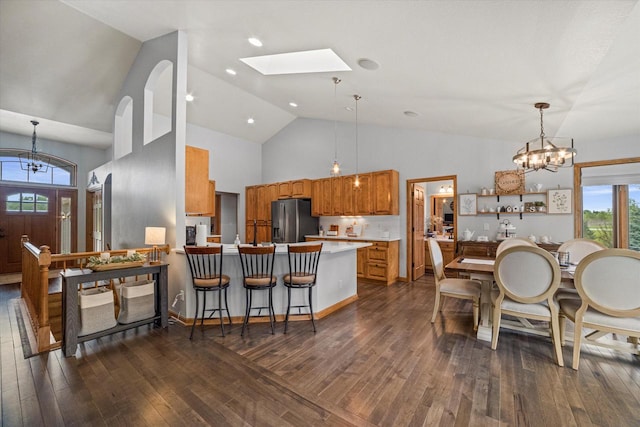 S91W35161 Prairie Ct, Eagle, WI 53119 - kitchen featuring a chandelier, stainless steel fridge, brown cabinetry, light countertops, and a peninsula
