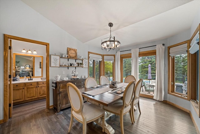 S91W35161 Prairie Ct, Eagle, WI 53119 - dining area with dark wood finished floors, lofted ceiling, baseboards, and a chandelier