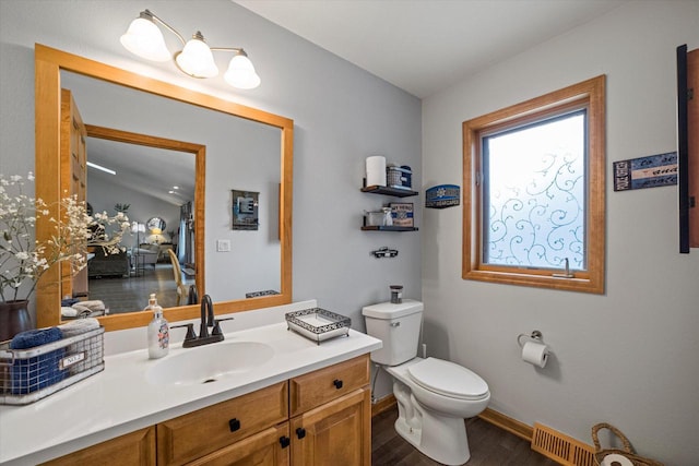 S91W35161 Prairie Ct, Eagle, WI 53119 - bathroom featuring wood finished floors, vanity, toilet, and baseboards