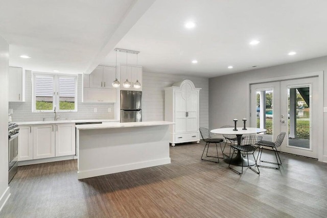 24722 84th St, Salem, WI 53168 - kitchen featuring stainless steel appliances, french doors, dark wood-style flooring, a sink, and white cabinetry