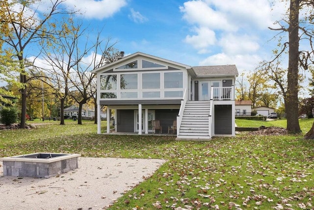 24722 84th St, Salem, WI 53168 - back of house featuring a fire pit, stairs, a lawn, a sunroom, and a patio