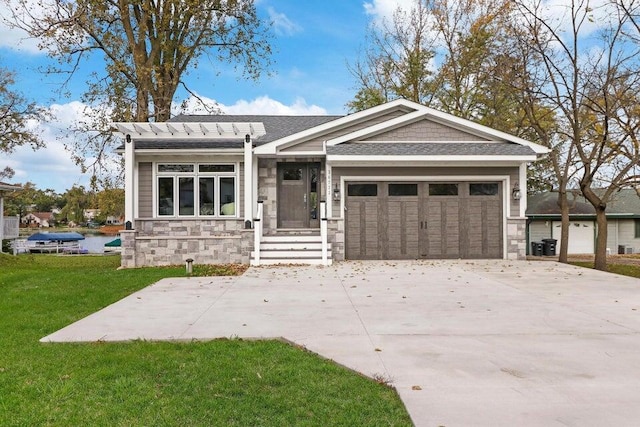 24722 84th St, Salem, WI 53168 - view of front facade featuring stone siding, an attached garage, a front lawn, concrete driveway, and roof with shingles