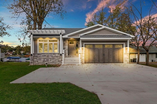 24722 84th St, Salem, WI 53168 - ranch-style home featuring stone siding, a front lawn, a garage, driveway, and roof with shingles
