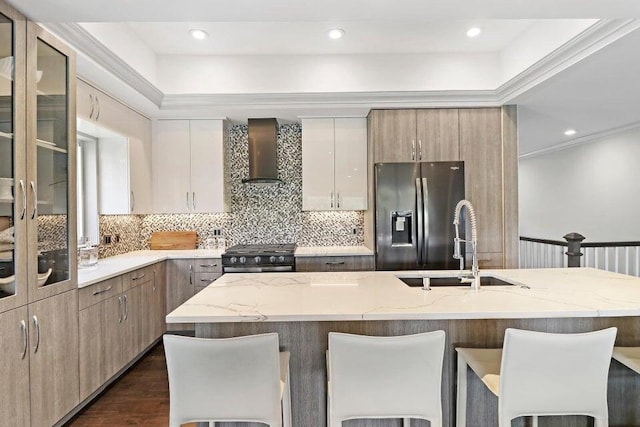24722 84th St, Salem, WI 53168 - kitchen featuring stainless steel refrigerator with ice dispenser, gas stove, a sink, wall chimney range hood, and a kitchen bar