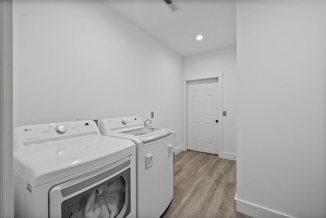 W3920 Lake Shore Dr, Lake Geneva, WI 53147 - laundry area with washing machine and dryer, light wood finished floors, and baseboards
