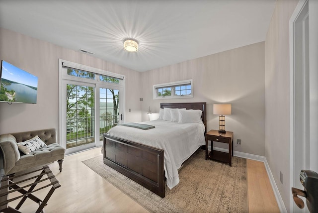 W3920 Lake Shore Dr, Lake Geneva, WI 53147 - bedroom featuring access to outside, wood finished floors, and baseboards