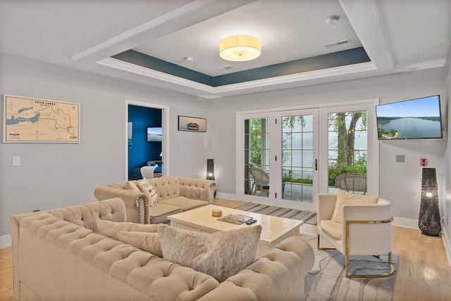 W3920 Lake Shore Dr, Lake Geneva, WI 53147 - living room featuring a raised ceiling, baseboards, and light wood-type flooring