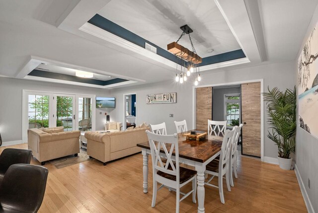 W3920 Lake Shore Dr, Lake Geneva, WI 53147 - dining area featuring a raised ceiling, plenty of natural light, and light wood-style flooring