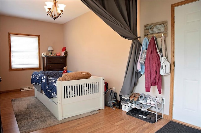 203 E Maple St, Thorp, WI 54771 - bedroom with a chandelier and wood finished floors
