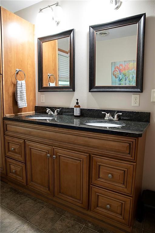 203 E Maple St, Thorp, WI 54771 - bathroom with double vanity and tile patterned flooring