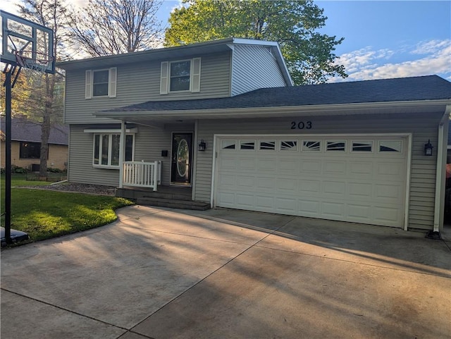203 E Maple St, Thorp, WI 54771 - traditional-style house with concrete driveway, a garage, and a front yard