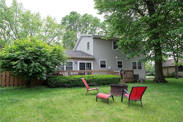 203 E Maple St, Thorp, WI 54771 - rear view of property featuring a deck, a fire pit, and a yard