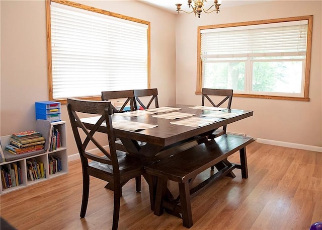 203 E Maple St, Thorp, WI 54771 - dining area with a chandelier and light wood-type flooring