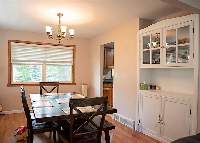 203 E Maple St, Thorp, WI 54771 - dining room featuring a chandelier and light wood-style flooring
