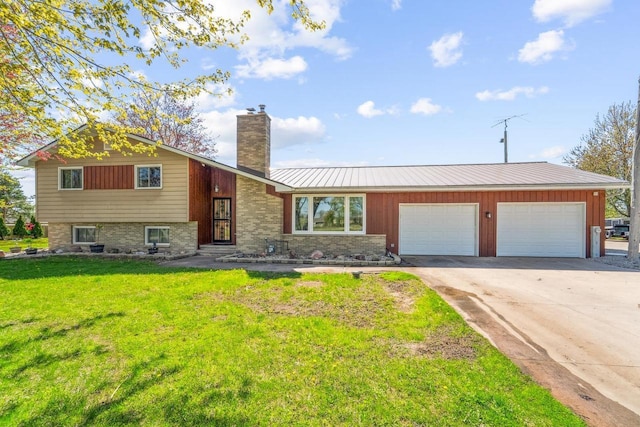 1116 Lake Park Rd, Menasha, WI 54952 - tri-level home featuring a chimney, a garage, a front yard, driveway, and metal roof