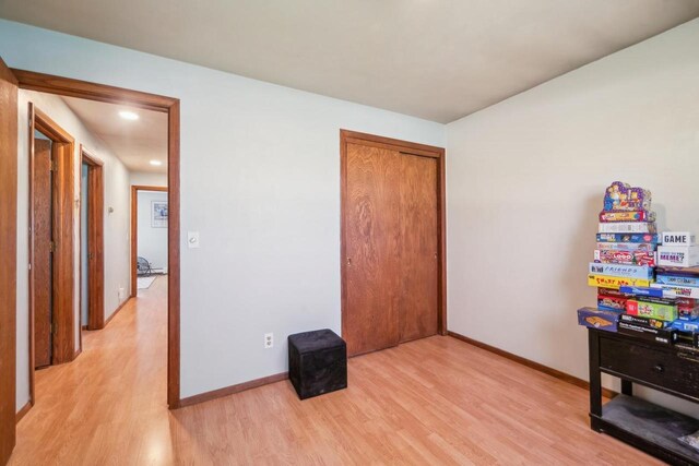 1116 Lake Park Rd, Menasha, WI 54952 - bedroom featuring light wood-style floors, baseboards, and a closet