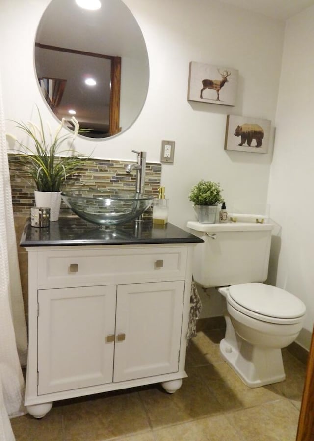 7320 5th Ave, Kenosha, WI 53143 - bathroom featuring decorative backsplash, vanity, toilet, and tile patterned floors
