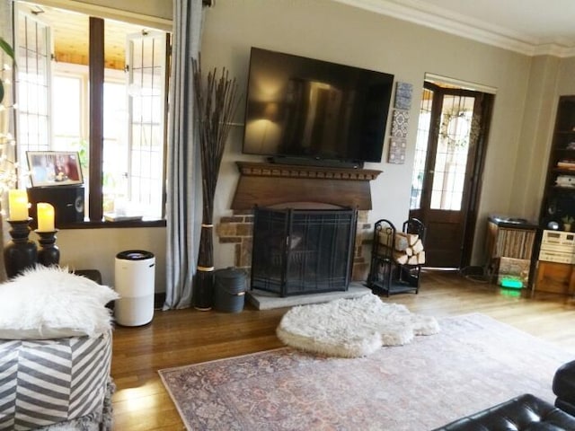 7320 5th Ave, Kenosha, WI 53143 - living area with wood finished floors, ornamental molding, and a fireplace with raised hearth