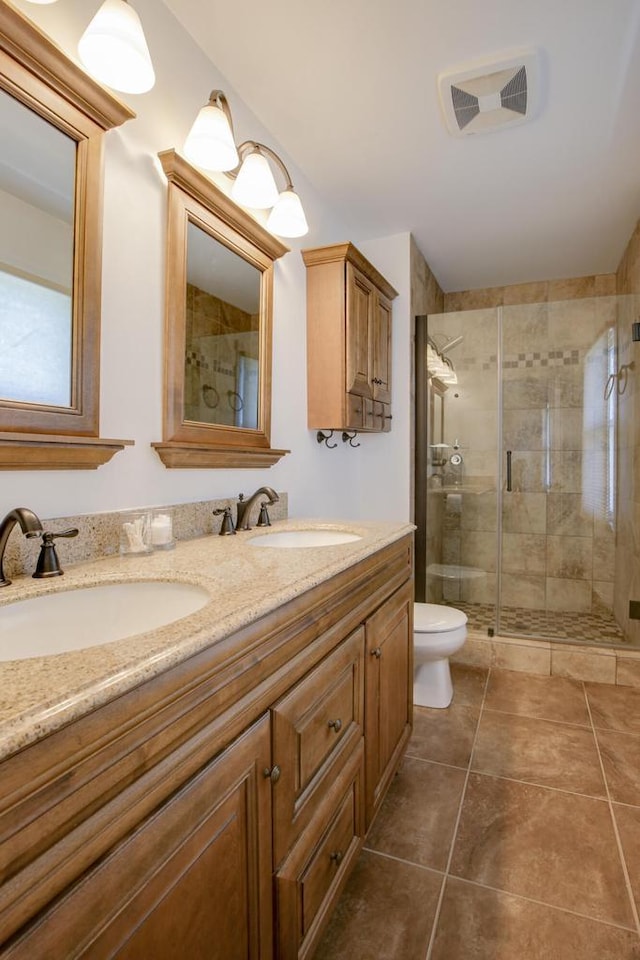 6622 96th Ave, Kenosha, WI 53142 - full bath featuring a shower stall, double vanity, toilet, and tile patterned flooring