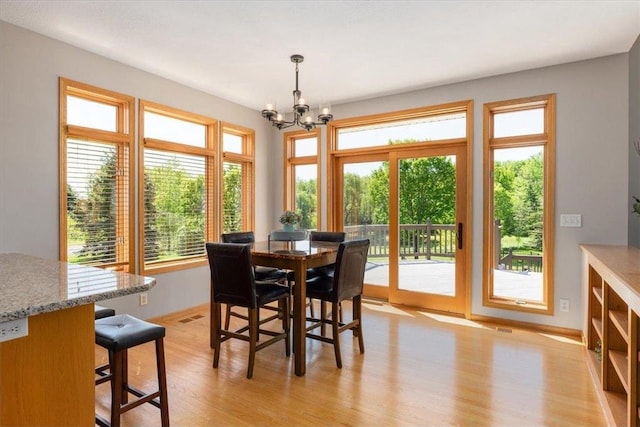 15210 Painters Lane Cir, Stillwater, MN 55082 - dining space featuring a chandelier, light wood-type flooring, and baseboards