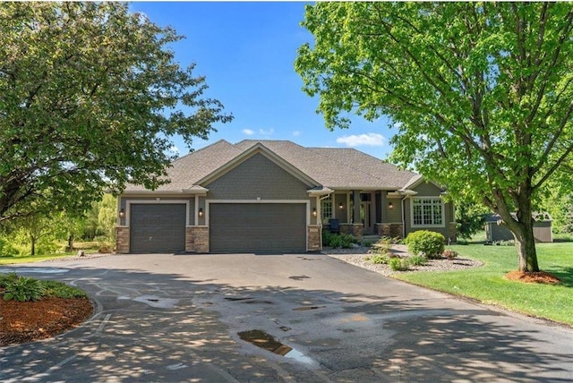 15210 Painters Lane Cir, Stillwater, MN 55082 - craftsman-style house with stone siding, driveway, an attached garage, and a front lawn