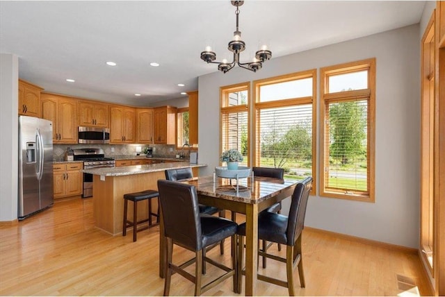 15210 Painters Lane Cir, Stillwater, MN 55082 - dining space with healthy amount of natural light, a chandelier, light wood finished floors, baseboards, and recessed lighting